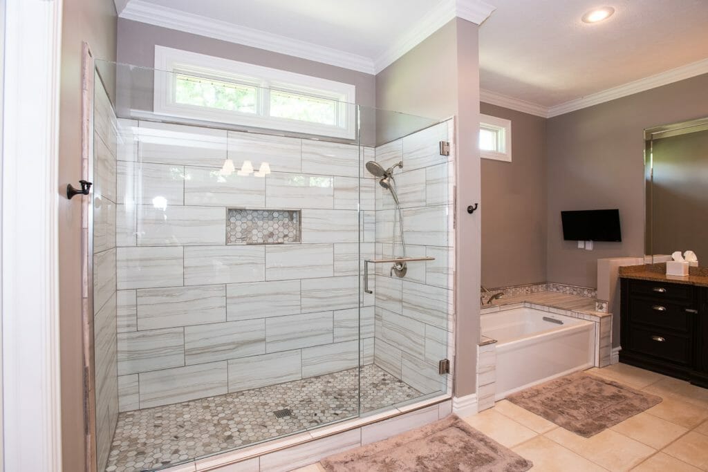 walk-in shower with glass doors and garden tub