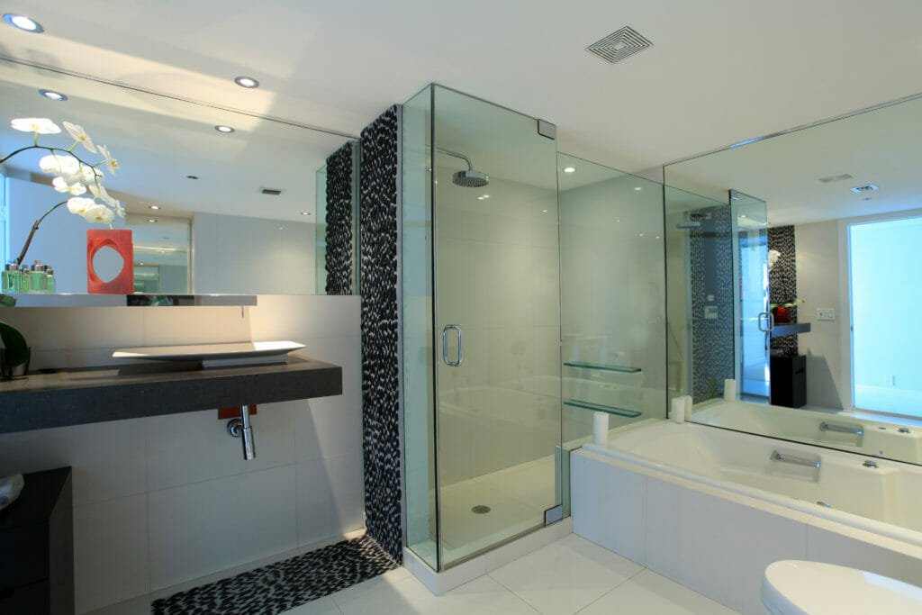 Luxury bathroom details of stone, tile, and glass doors.
